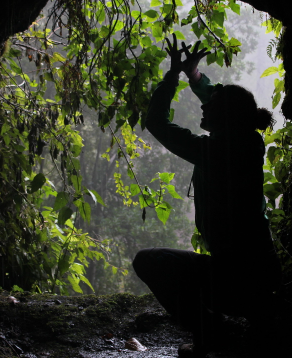 Person in kneeling position in a cave