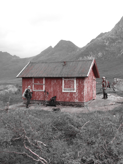 Red cabin in a black and white mountain landscape