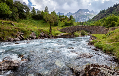 River under a bridge with mountain scenery